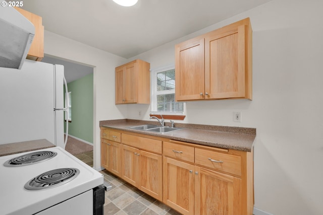 12813 Village Rd Unit 12, Swisshome, OR 97480 - kitchen with light brown cabinetry, white appliances, baseboards, and a sink