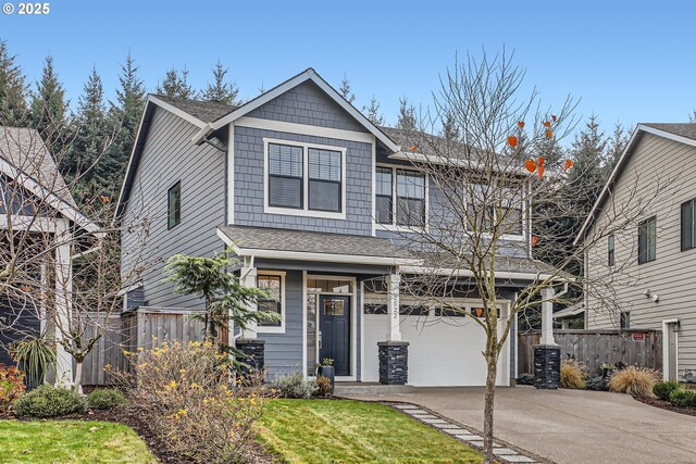 view of front of property with a front yard and a garage