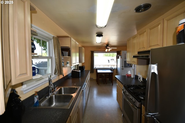 719 W 11th St, The Dalles, OR 97058 - kitchen featuring under cabinet range hood, dark countertops, appliances with stainless steel finishes, and a sink