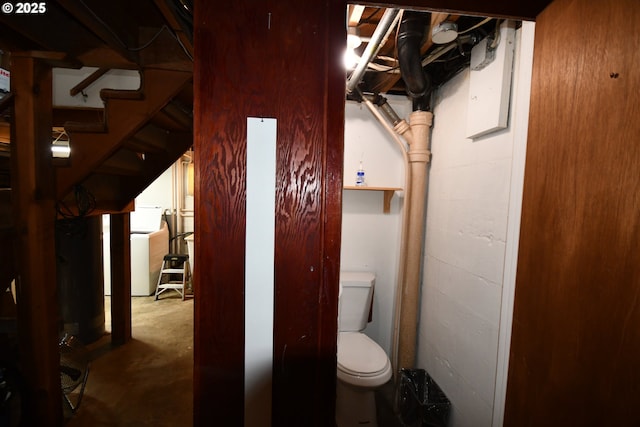 719 W 11th St, The Dalles, OR 97058 - bathroom featuring toilet, washer / dryer, and unfinished concrete flooring