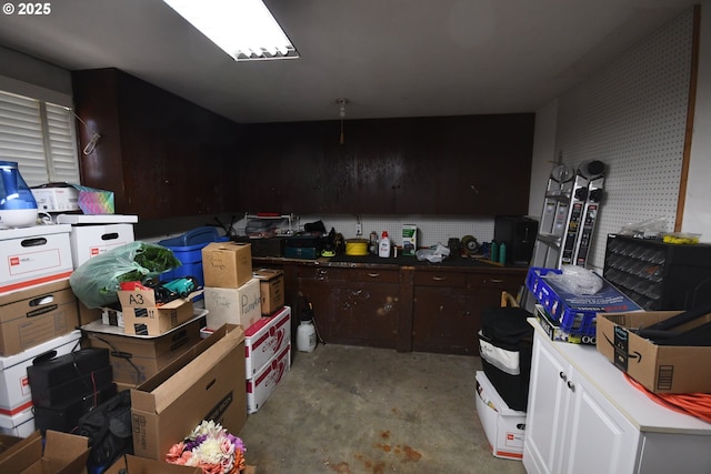 719 W 11th St, The Dalles, OR 97058 - kitchen with dark brown cabinets and concrete flooring