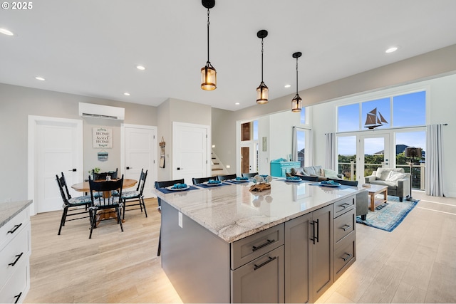 kitchen with recessed lighting, gray cabinetry, light wood finished floors, and a wall mounted air conditioner