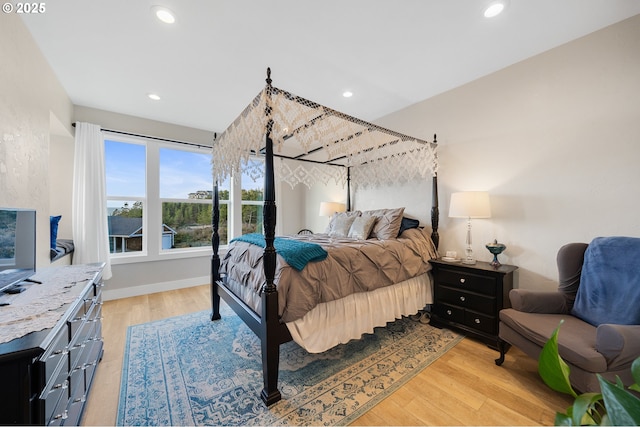 bedroom featuring recessed lighting, baseboards, and light wood-style flooring