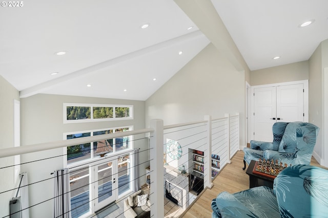 corridor with recessed lighting, lofted ceiling with beams, wood finished floors, and an upstairs landing