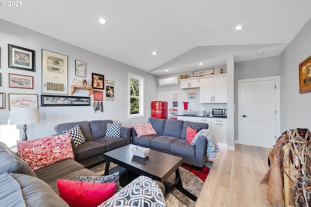 living room with light wood-style floors, an AC wall unit, recessed lighting, and lofted ceiling