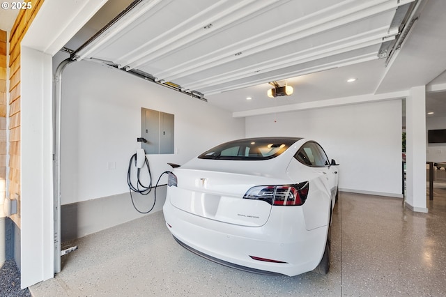 garage with recessed lighting, a garage door opener, and electric panel