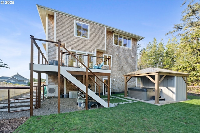 back of house with stairs, ac unit, a hot tub, a wooden deck, and a yard