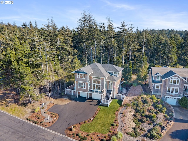bird's eye view with a wooded view
