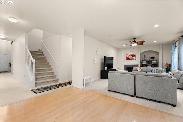 20053 SW 54th Ter, Tualatin, OR 97062 - carpeted living room with a ceiling fan, stairs, a fireplace, wood finished floors, and recessed lighting