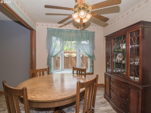 19838 NE Wasco St, Portland, OR 97230 - dining space with wallpapered walls, light wood finished floors, and ceiling fan