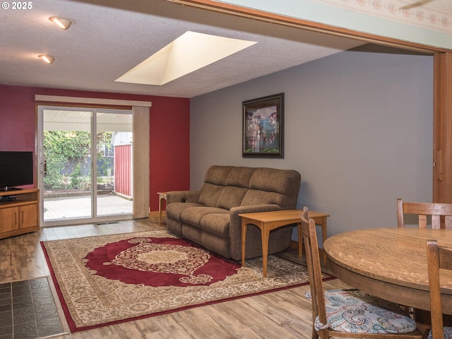 19838 NE Wasco St, Portland, OR 97230 - living room with a skylight, wood finished floors, and a textured ceiling