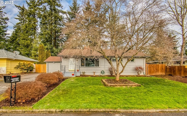 view of front of home featuring a garage and a front lawn