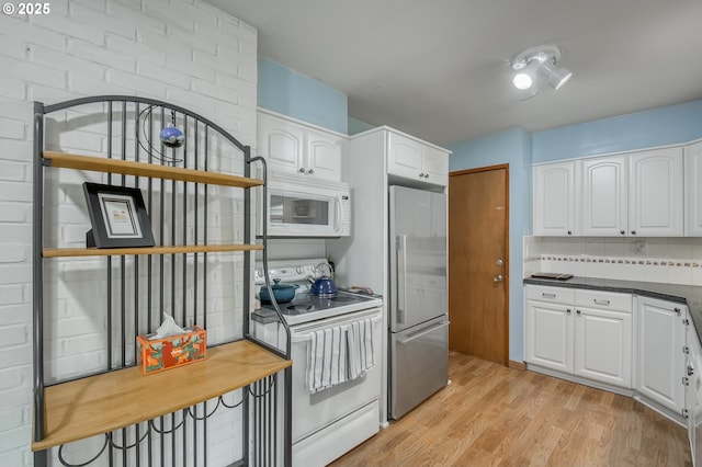 kitchen featuring white cabinetry, white appliances, and decorative backsplash