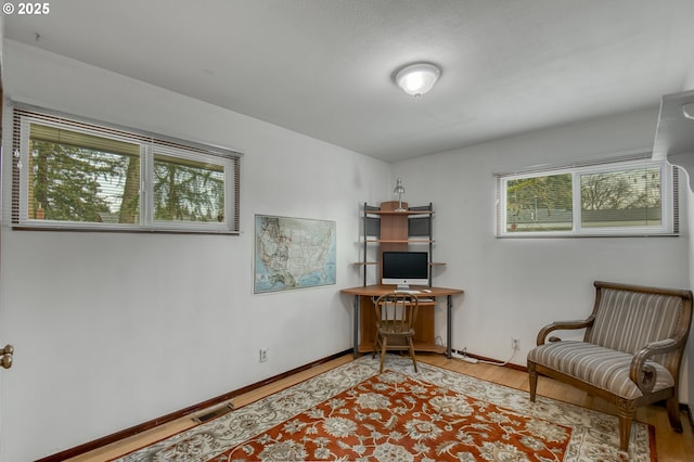 home office featuring plenty of natural light and light hardwood / wood-style flooring