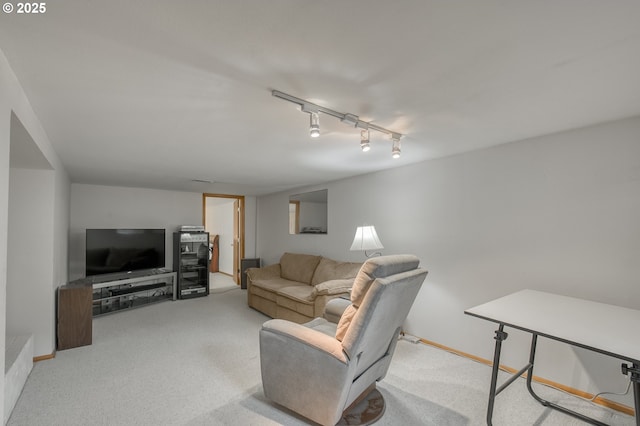 carpeted living room featuring track lighting