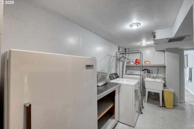 laundry area with sink and washer and clothes dryer