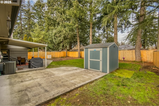 view of yard with a storage shed, a patio, and central air condition unit