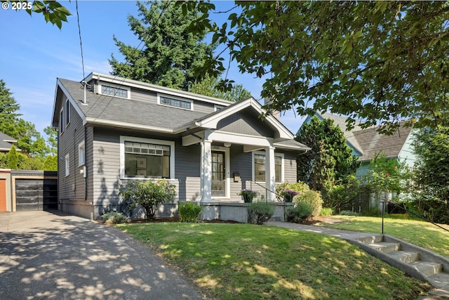 1982 SE 30th Ave, Portland, OR 97214 - bungalow-style home featuring a porch, a front lawn, an outbuilding, and a garage