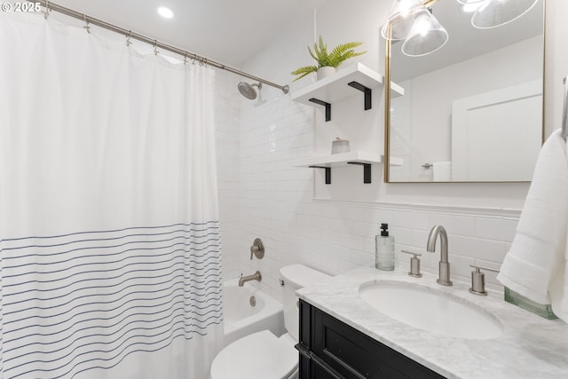bathroom featuring vanity, shower / bath combo, toilet, and tile walls