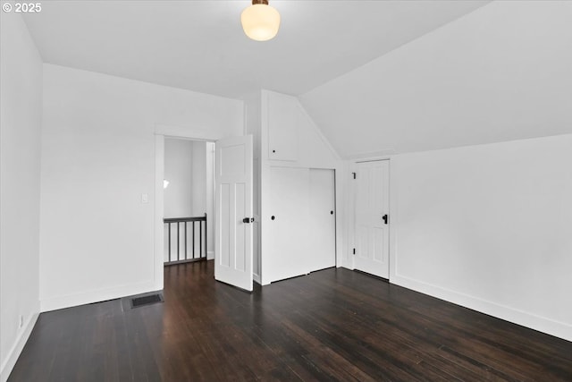 bonus room featuring dark wood-type flooring and lofted ceiling