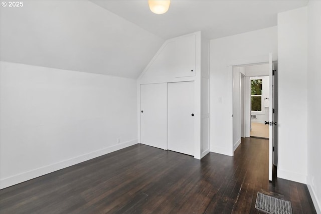 bonus room featuring dark wood-type flooring and lofted ceiling