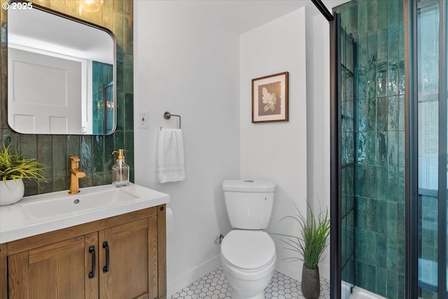 bathroom with walk in shower, vanity, tile patterned floors, and toilet