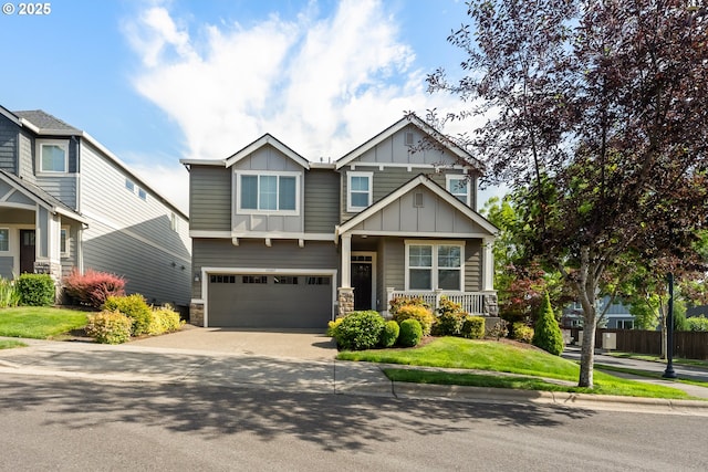 17007 NW Reuben Ln, Portland, OR 97229 - craftsman-style house featuring board and batten siding, a garage, driveway, stone siding, and a porch