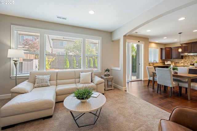 17007 NW Reuben Ln, Portland, OR 97229 - carpeted living area featuring arched walkways and recessed lighting