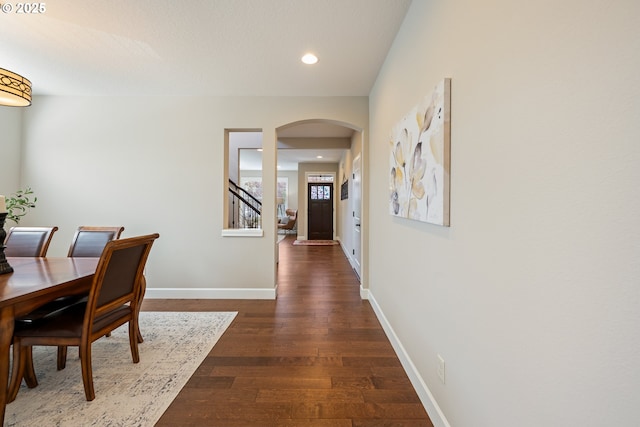 17007 NW Reuben Ln, Portland, OR 97229 - dining area with arched walkways, dark wood-style floors, recessed lighting, and stairs