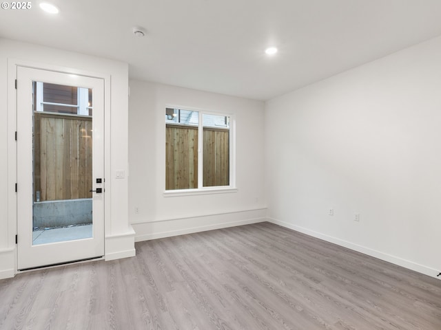 spare room with light hardwood / wood-style floors