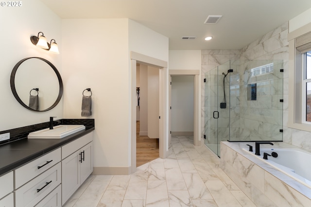 bathroom with shower with separate bathtub and vanity