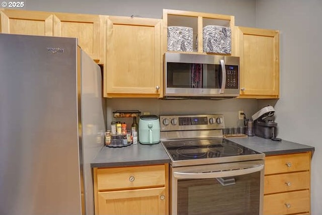 kitchen featuring light brown cabinetry and appliances with stainless steel finishes