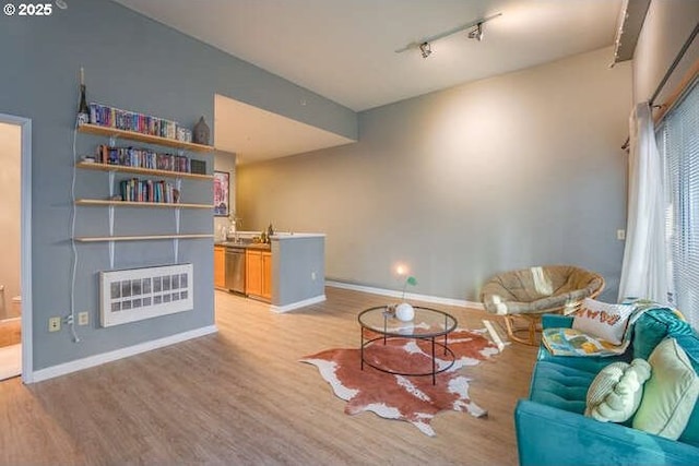 sitting room with track lighting and light hardwood / wood-style floors