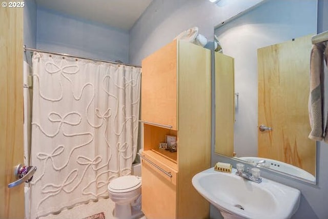 full bathroom with toilet, shower / bath combo with shower curtain, and sink