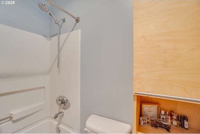 bathroom featuring shower / tub combination and toilet