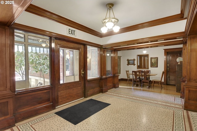 foyer entrance with a notable chandelier and ornamental molding