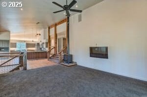 unfurnished living room with ceiling fan and carpet floors