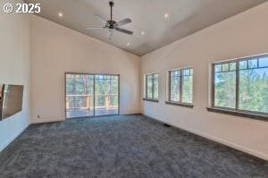 unfurnished living room with a ceiling fan, dark colored carpet, lofted ceiling, and recessed lighting