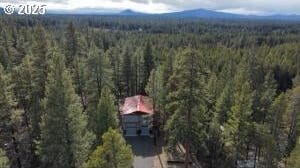 aerial view with a mountain view and a view of trees