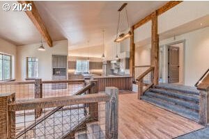 dining space with vaulted ceiling with beams