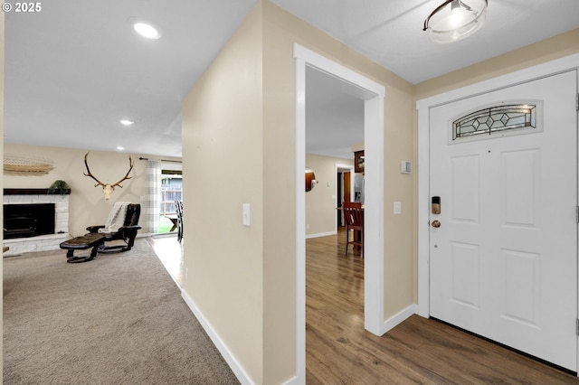 1808 S 4th St, Cottage Grove, OR 97424 - foyer entrance featuring baseboards, recessed lighting, a fireplace with raised hearth, and dark wood-style flooring
