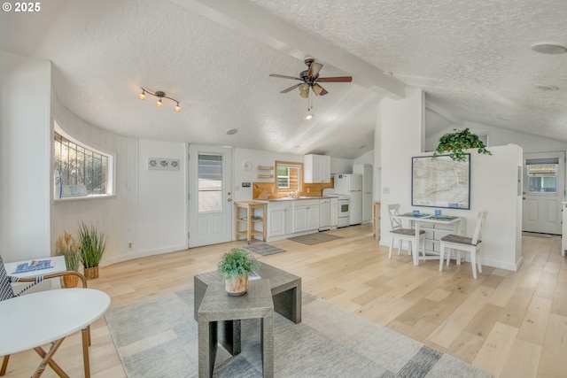 19609 NE Marine Dr Unit E 10, Gresham, OR 97230 - living room with a textured ceiling, ceiling fan, light wood finished floors, plenty of natural light, and baseboards