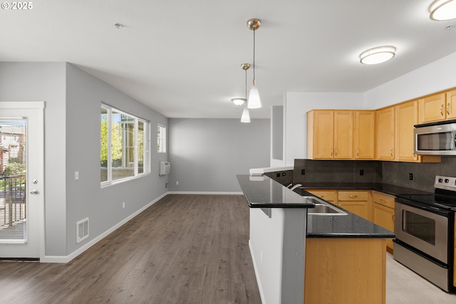645 NW Falling Waters Ln Unit 303, Portland, OR 97229 - kitchen with a sink, decorative backsplash, light brown cabinetry, stainless steel appliances, and visible vents