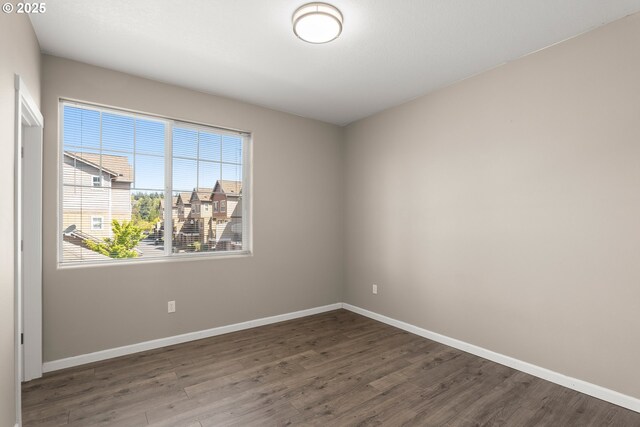 645 NW Falling Waters Ln Unit 303, Portland, OR 97229 - unfurnished room with wood finished floors and baseboards