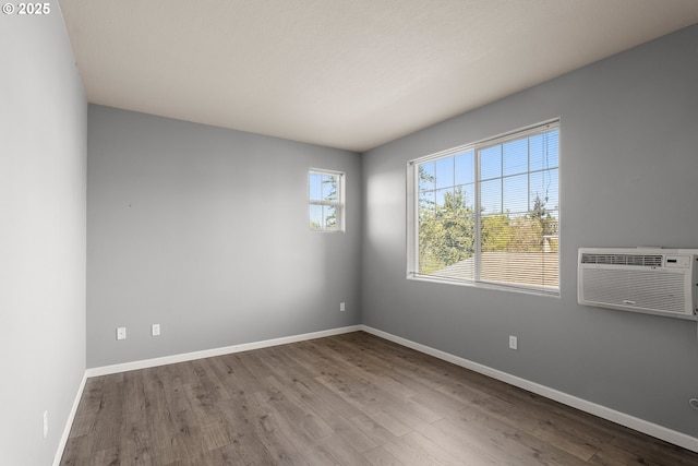 645 NW Falling Waters Ln Unit 303, Portland, OR 97229 - empty room with baseboards, wood finished floors, and a wall mounted AC
