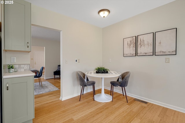 7817 N Washburne Ave, Portland, OR 97217 - dining space with baseboards, visible vents, and light wood finished floors