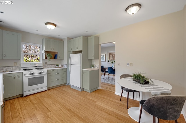 7817 N Washburne Ave, Portland, OR 97217 - kitchen featuring open shelves, white appliances, light wood-type flooring, light countertops, and green cabinetry