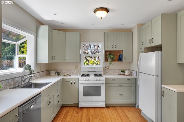 7817 N Washburne Ave, Portland, OR 97217 - kitchen featuring white appliances, a healthy amount of sunlight, a sink, and light countertops