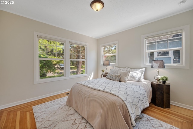 7817 N Washburne Ave, Portland, OR 97217 - bedroom featuring baseboards, ornamental molding, and light wood finished floors