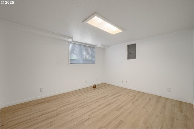 7817 N Washburne Ave, Portland, OR 97217 - below grade area with light wood-style floors, baseboards, and electric panel